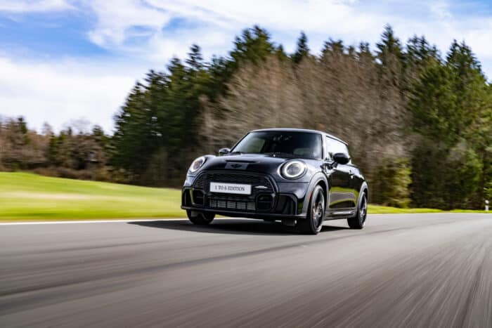 The John Cooper Works driving down a highway at a high speed.
