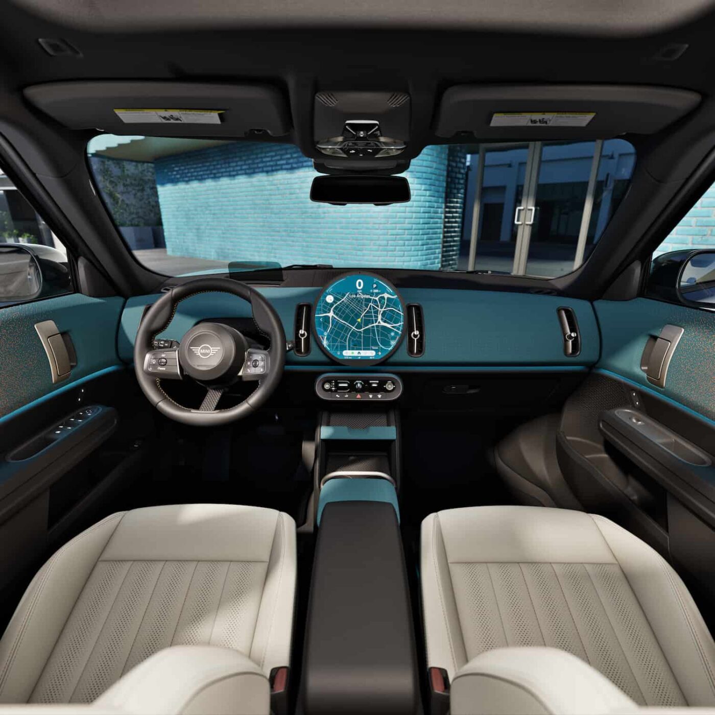 The interior of a Mini Cooper, featuring a large circular display with navigation. Strong Mini Cooper crash rating scores make it a reliable compact car.