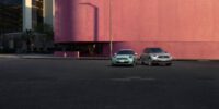 2023 Mini Cooper parked beside Mini Cooper 2022 in city street setting, showing design differences between both model years.